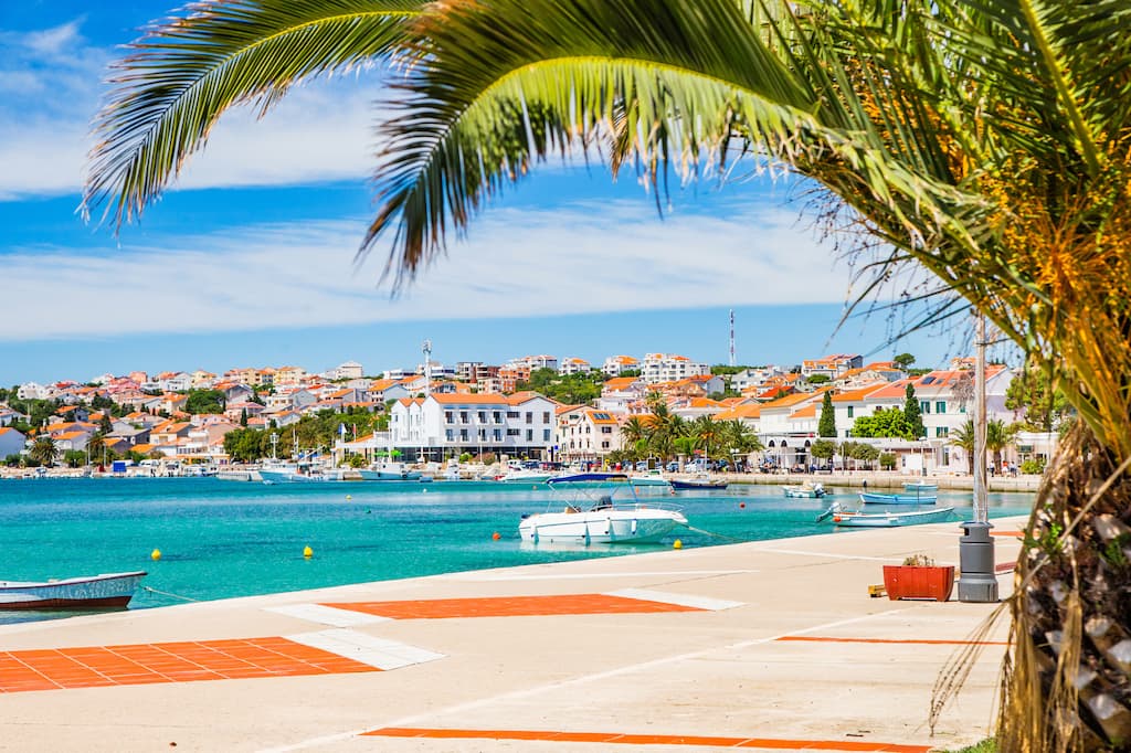 Croácia, palmeiras em frente ao mar na cidade de novalja, na ilha de pag